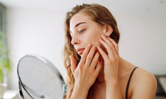 Woman examining sensitive facial skin before using natural tallow skincare
